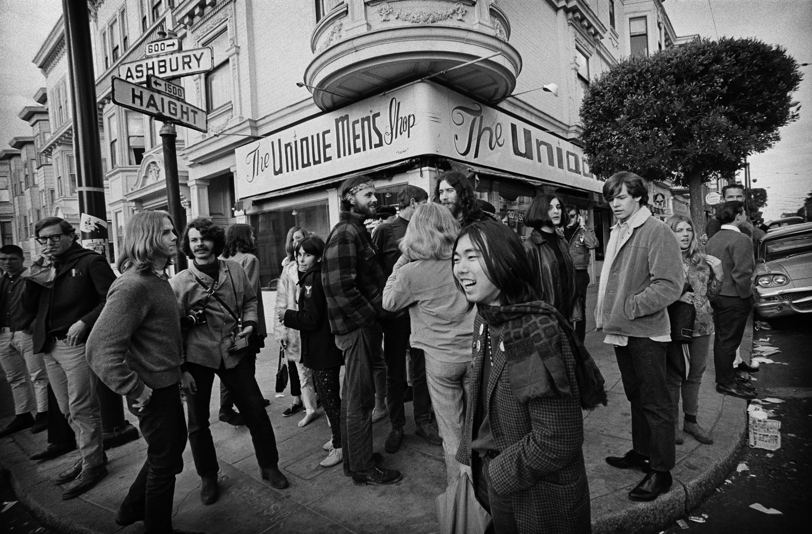 A crowd at the corner of Haight and Ashbury Streets
