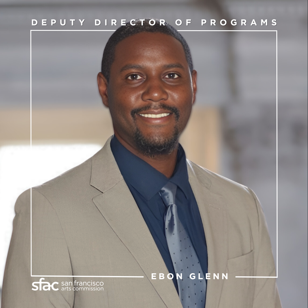 Image of Ebon Glenn in a tan suit, smiling